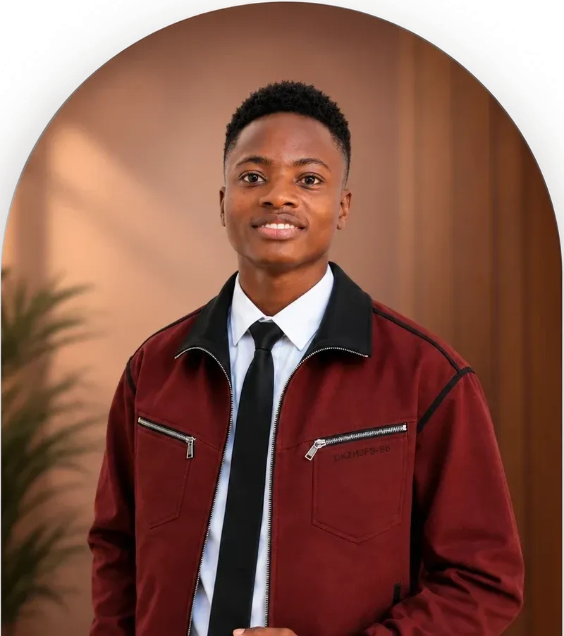 Innocent smiling, wearing a burgundy jacket and black tie