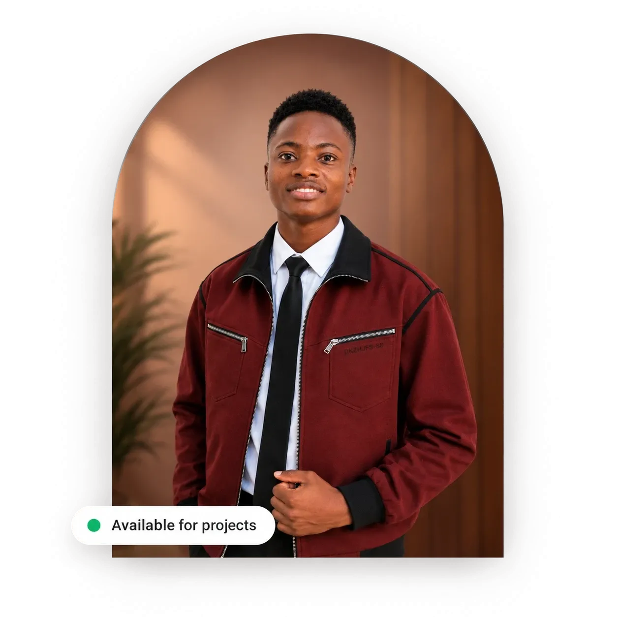 Innocent, founder of Scale With Innocent, smiling in a burgundy jacket, white shirt and black tie